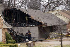 Home exterior fire damage to siding and roof.