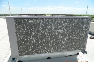 Rooftop air conditioning unit with hail damage.