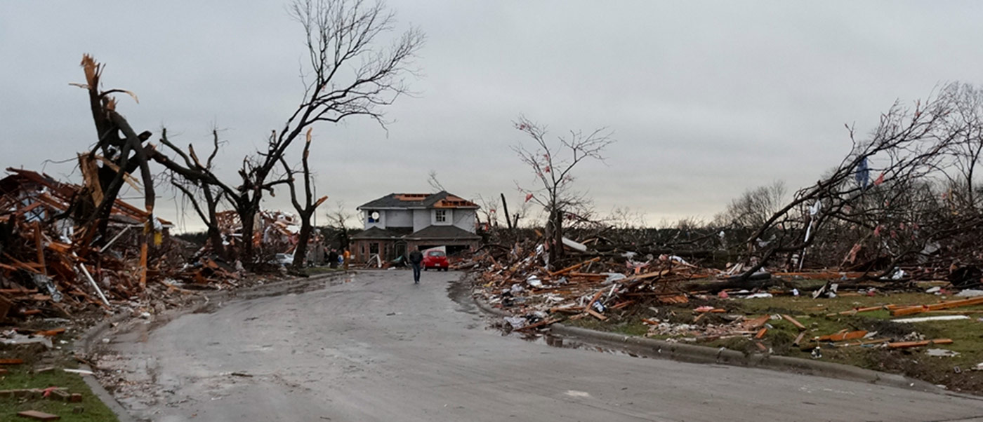 tornado damage street with house debris everywhere